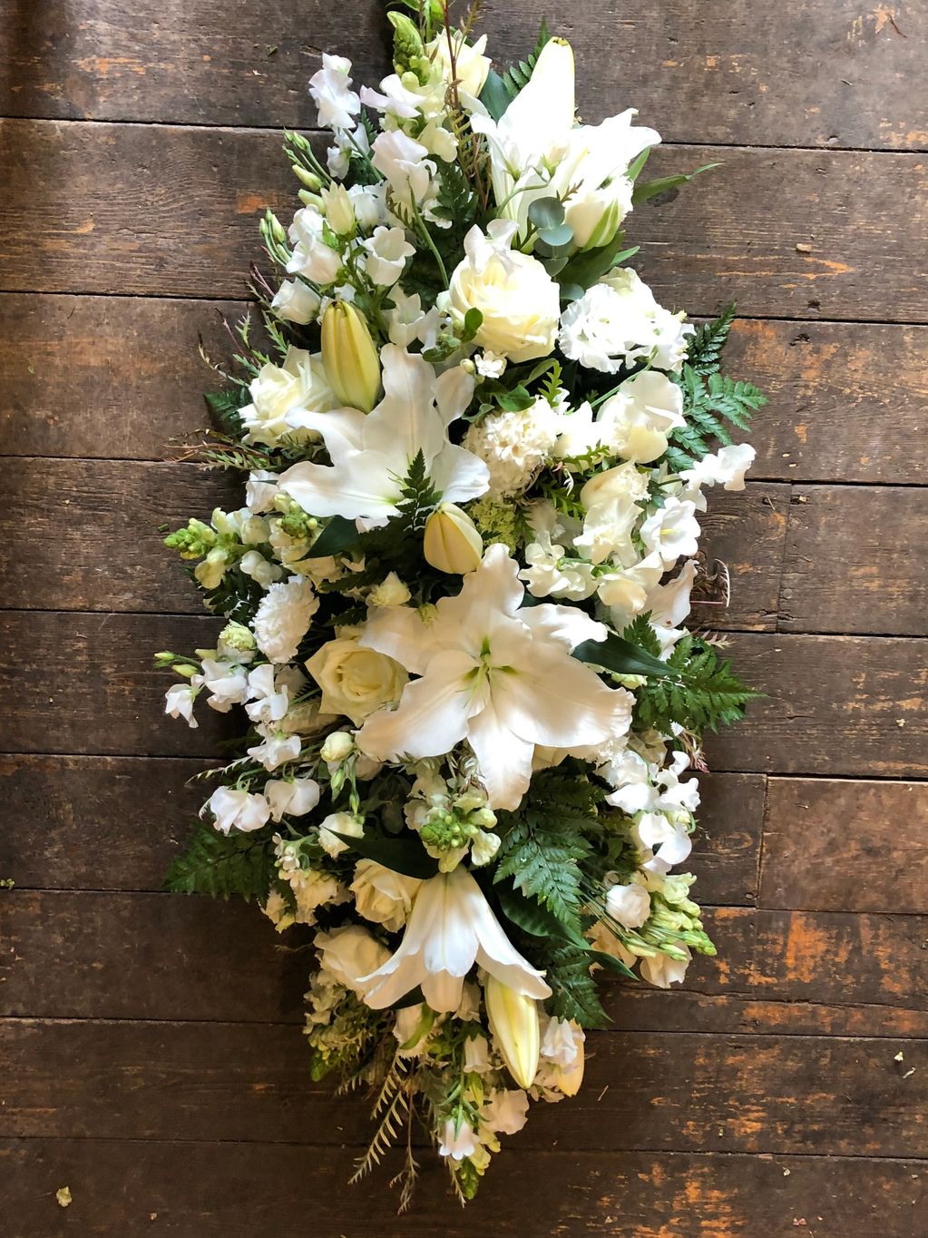 Funeral tribute flowers. Double ended coffin spray. London