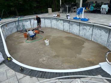 The guys fixing the pool bottom and prepping for a new liner.