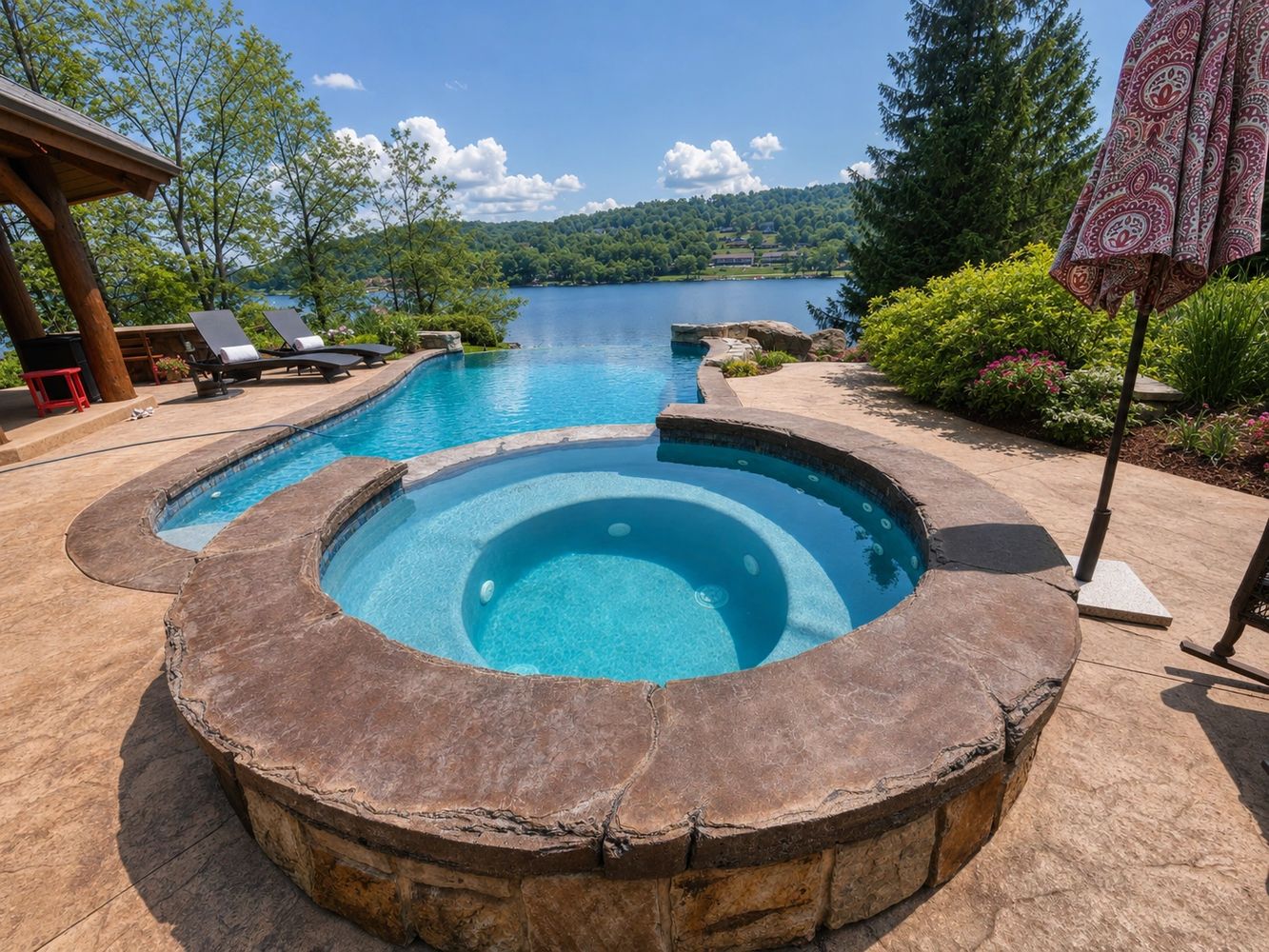 A luxurious backyard pool and hot tub overlooking deepcreek lake, between oakland and mchenry.