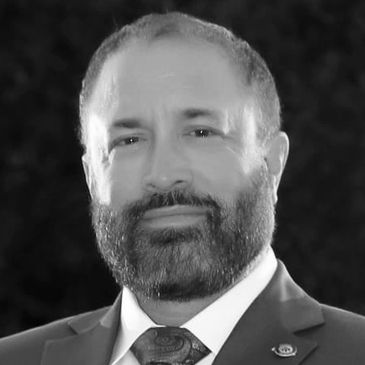 Man with a beard in a blue suit.