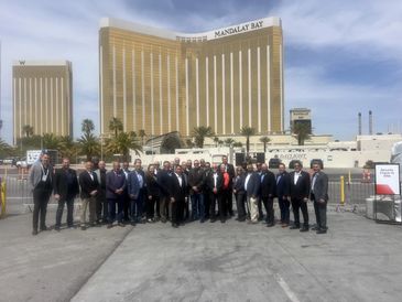 Group photo of people in front of Mandalay Bay hotel.