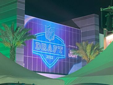 NFL Draft 2022 neon sign on building at night.