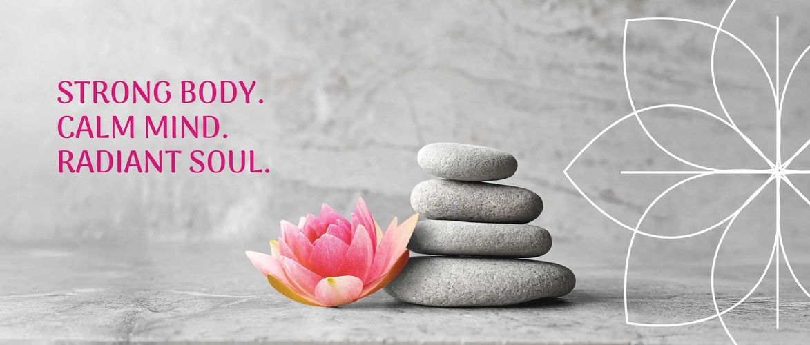 Stacked stones and a pink flower symbolize balance and calmness with an inspiring message.