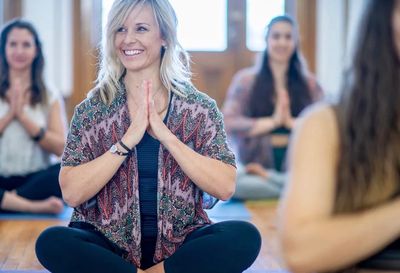 Women practicing yoga meditation in a group session.