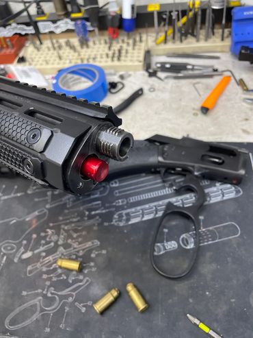 The Mad Pig Tracker rifle broken down. The interrupted threads of the Hollywood Takedown are clearly