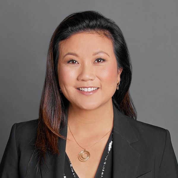 Photo of Diana Iketani Iorlano (Smiling Asian woman in business attire)
