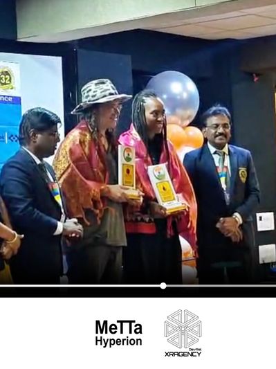 Two award recipients stand with officials at a ceremony, holding trophies and smiling.