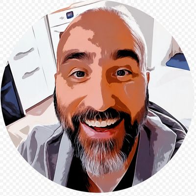 Close-up cartoon-style portrait of a cheerful man with a beard and bright eyes.