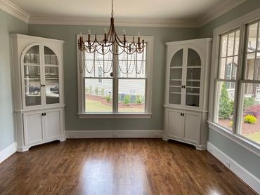 custom home dining room with built in glass cabinets