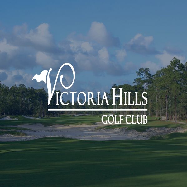 Logo of Victoria Hills Golf Club over a scenic golf course background.