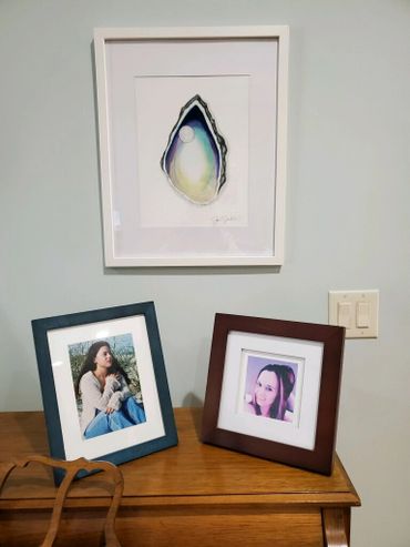 Oyster watercolor art painting hanging on interior wall in beach home.