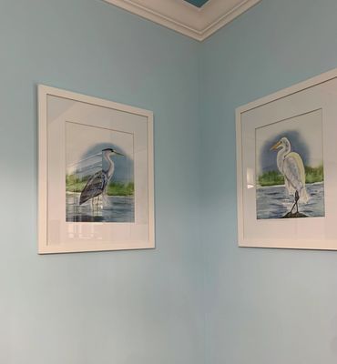 Blue Heron and Egret watercolor art painting hanging on interior wall in beach home.