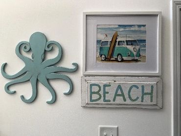 VW bus with surfboard hanging on wall in beach home.