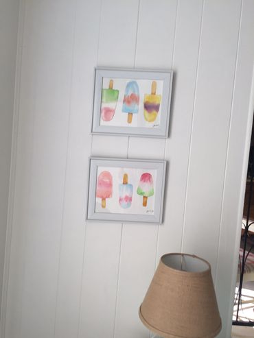 Watercolor art Popsicle hanging on interior wall in beach home.