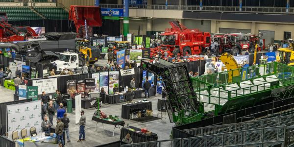 Indoor machinery and equipment expo with attendees.