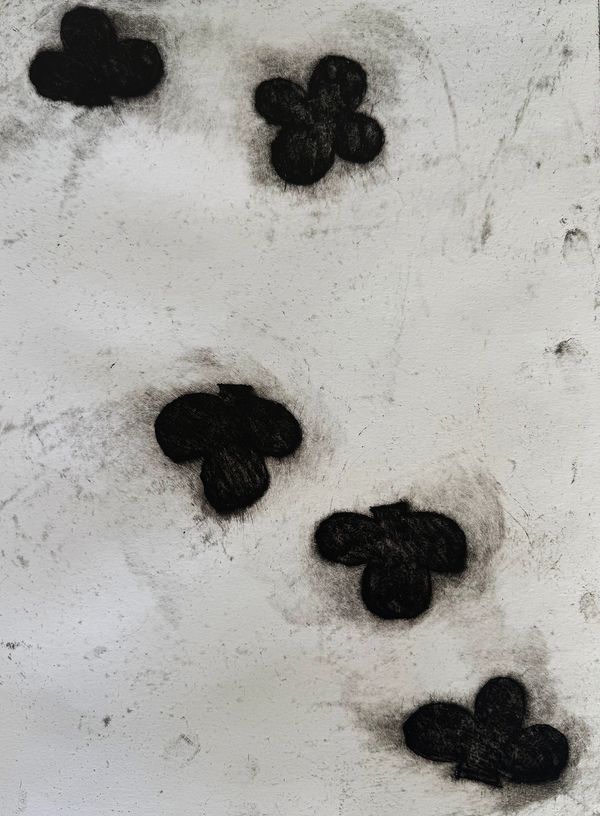 Black club symbols on a gray textured surface.