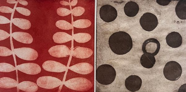 Two contrasting rugs with distinct patterns: red with leaf motifs and beige with black circles.