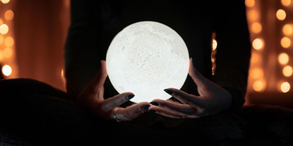 Woman holding glowing crystal ball