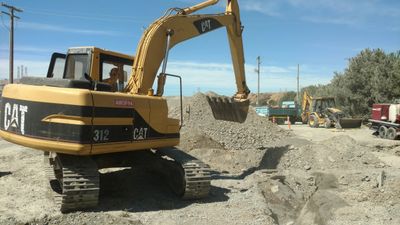 Excavator removing an old septic tank in Sunol, California. We have the contractors license for it.