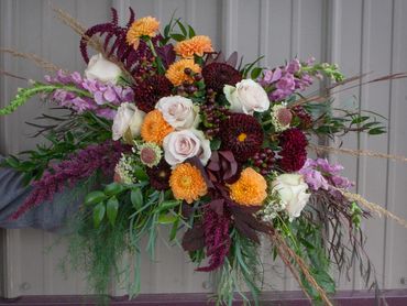 Lush textured fall bridal bouquet with roses, dahlias, snapdragons, scabiosa burgundy blush and oran
