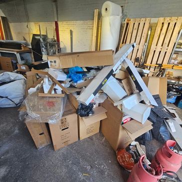 A WAREHOUSE FULL OF RUBBISH TASKED TO BE CLEARED BY WASTE BUSTERS STAFFORDSHIRE