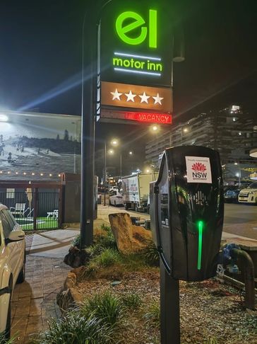 Black EV charger installed in a motel