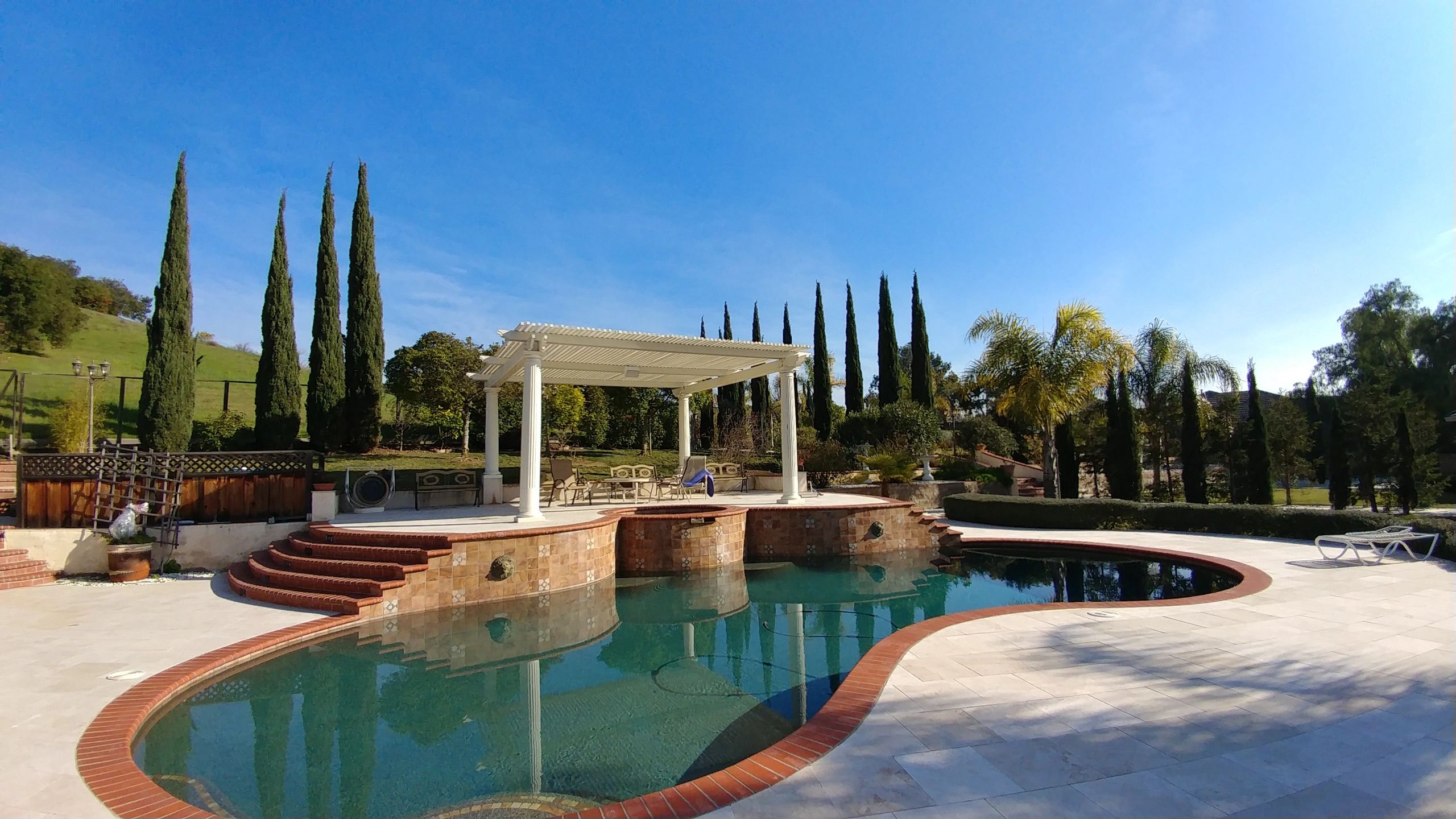 Backyard pool with view of golf course.