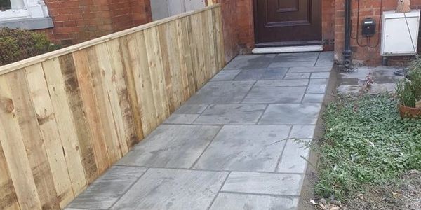 grey paving and hip height fence