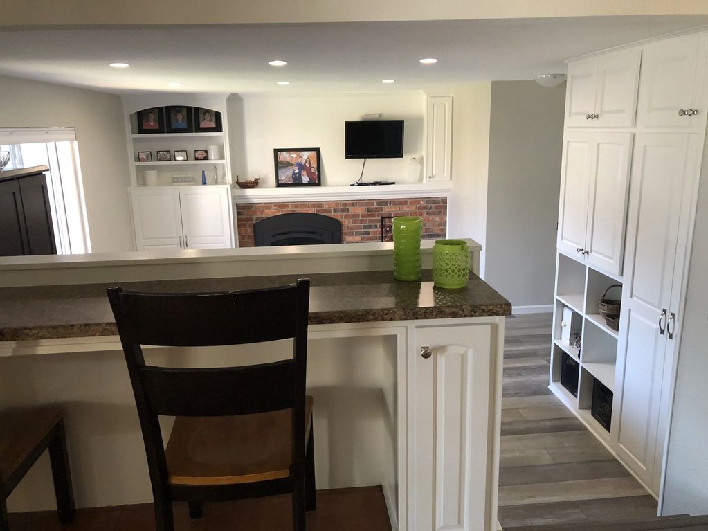 Wide view of the finished breakfast bar, storage wall, and mantel wall
