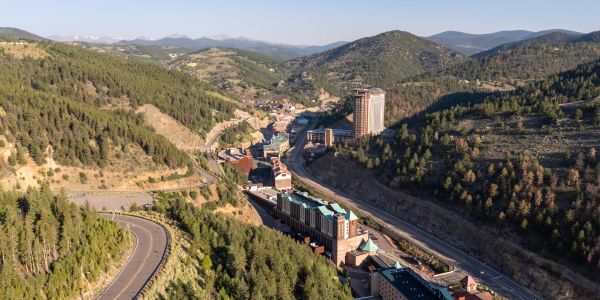 Mountain town nestled in a forested valley with winding roads.