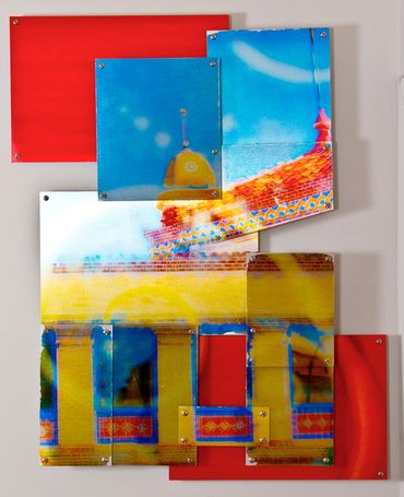 Red, yellow, and blue photo of a building across ten metal tiles