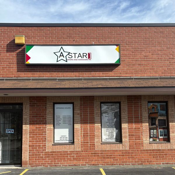 Brick storefront of A Star Doors and Hardware with business hours and services listed.