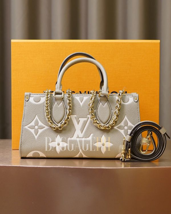 Elegant Louis Vuitton handbag with gold chain accents and detachable strap.