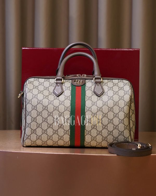 Luxury Gucci handbag with signature GG pattern and green-red-green stripe.