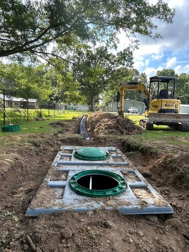 Construction site with drainage work and excavator.