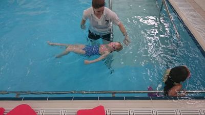 A little girl at a swimming course.
