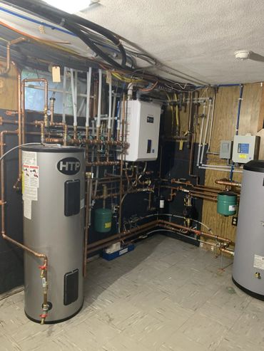 Upgraded mechanical room for Geothermal Radiant Heating system with Navien backup Combo Boiler