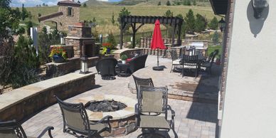 Outdoor patio with seating and a fire pit.