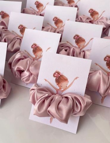 Pink satin hair scrunchies attached to ballerina cards.