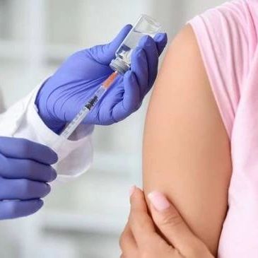 Person receiving a vaccine injection in the arm.