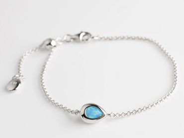 Teardrop Coast Pebble set with blue opalescent accents.