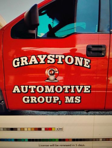 Red vehicle door with Graystone Automotive Group, MS logo.