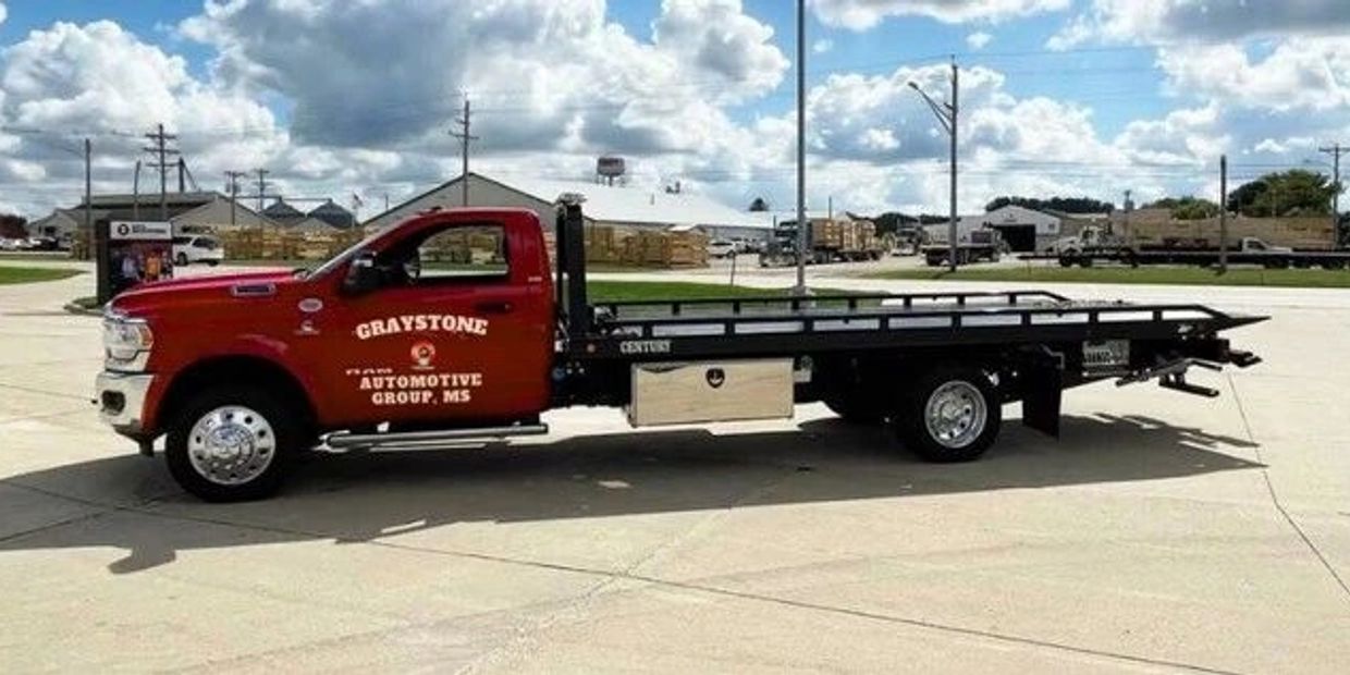Red flatbed tow truck from Graystone Automotive Group, MS.
