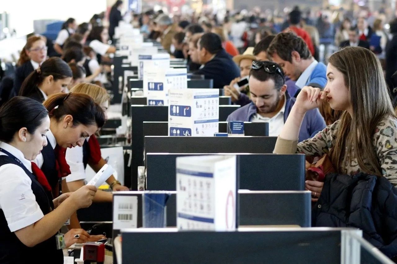 People at an airport counter are waiting for help.