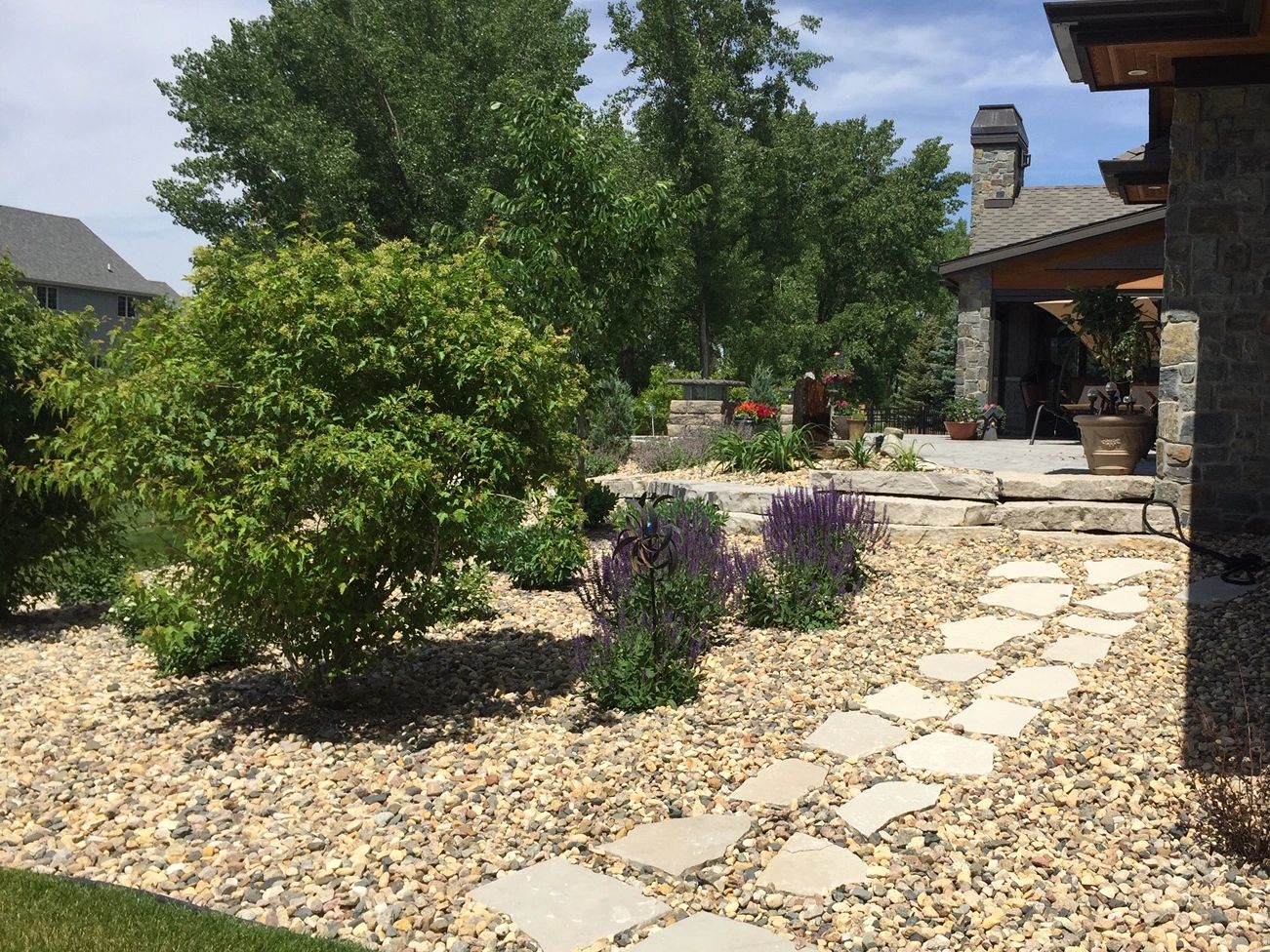 Expert Sioux Falls Landscaper Installs Stone Pathways, Perennial Shrubs, and Paver Patios