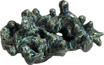 Abstract ceramic sculpture with intertwined human-like forms in blue-green glaze.