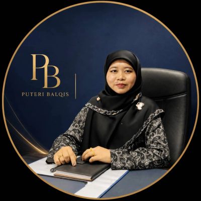 Woman in hijab sitting at desk with notebook.