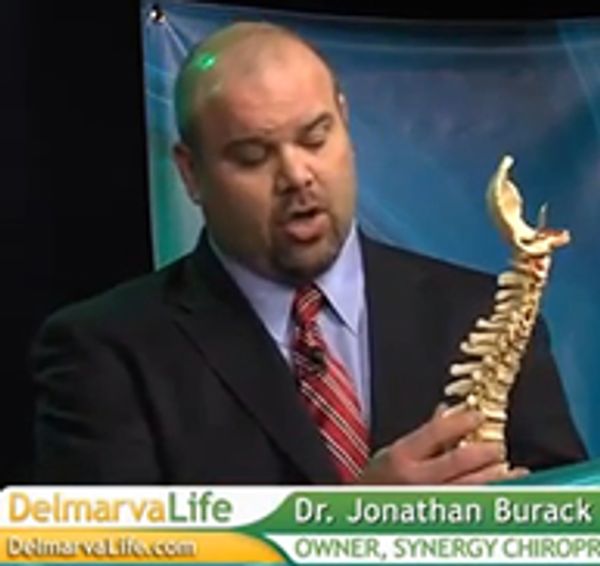 Dr. Jonathan Burack explaining a spinal model on Delmarva Life.