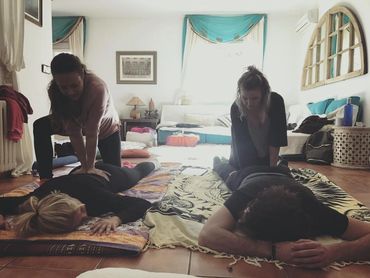 Hands-on Thai massage training session with students during professional massage course in Ibiza