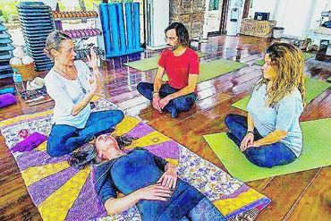 Holistic massage training session with students learning bodywork techniques in Ibiza